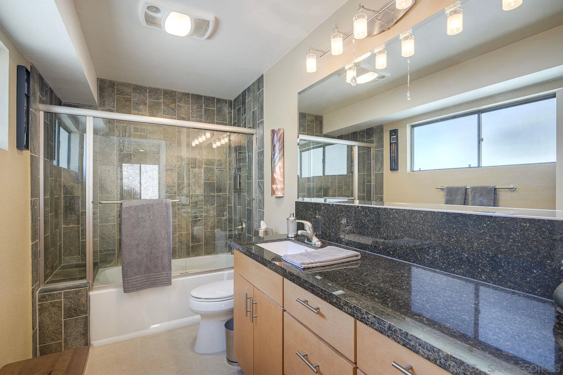 3467 Reynard Way, Unit A San Diego, CA 92103 - Photo 6 of 29 a spacious bathroom with a granite countertop sink toilet a large mirror and shower