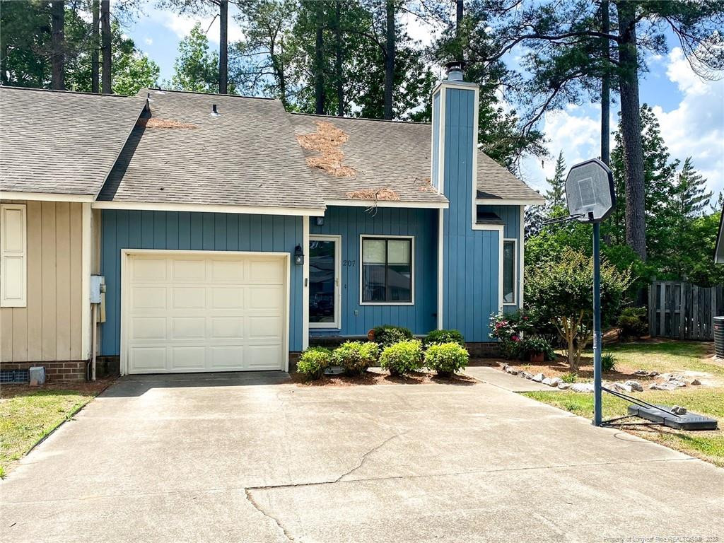 207 Charmant Road Lumberton, NC 28358 - Photo 24 of 24 a front view of a house with a yard and garage