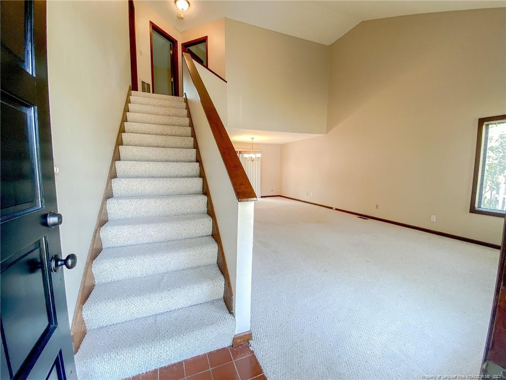 207 Charmant Road Lumberton, NC 28358 - Photo 3 of 24 a view of staircase with white walls and a window