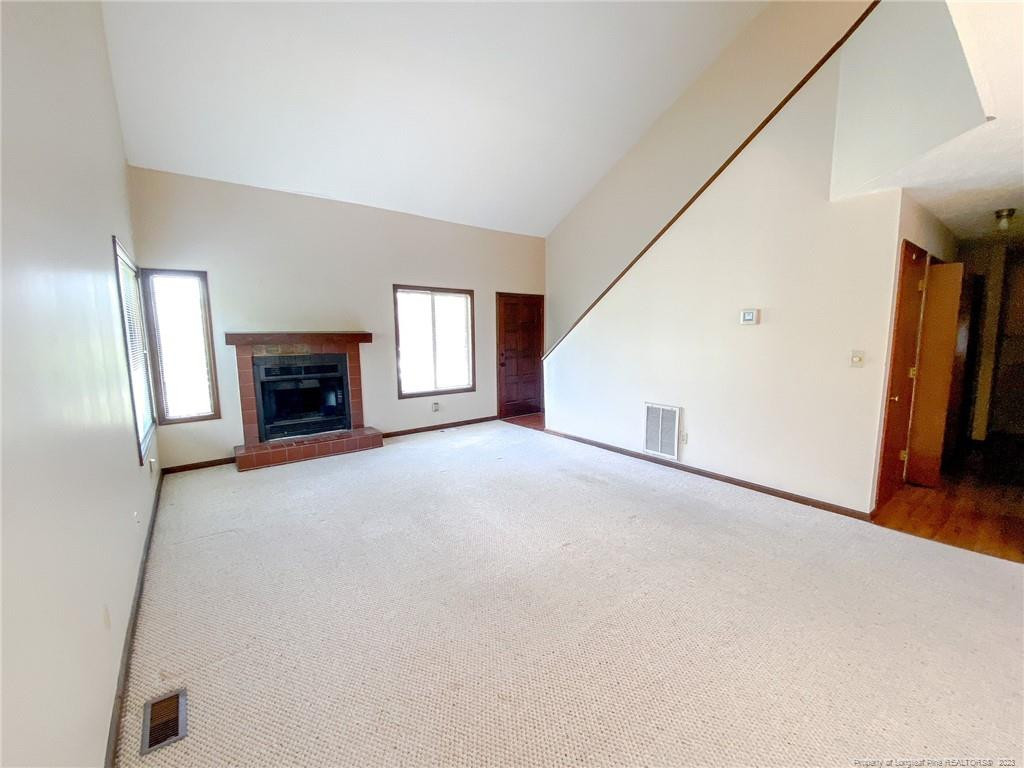207 Charmant Road Lumberton, NC 28358 - Photo 5 of 24 a view of empty room with a fireplace