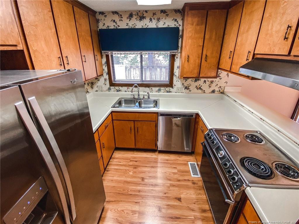 207 Charmant Road Lumberton, NC 28358 - Photo 7 of 24 a kitchen with a sink a stove and cabinets