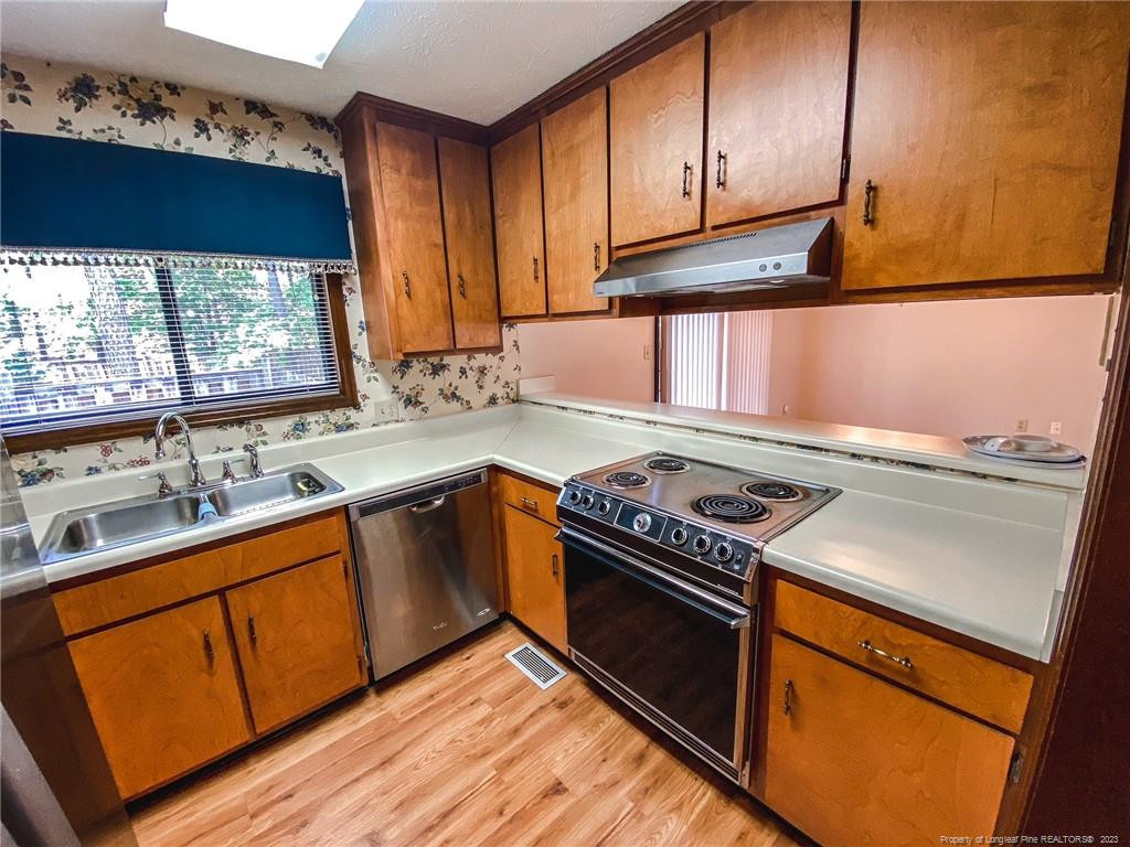 207 Charmant Road Lumberton, NC 28358 - Photo 9 of 24 a kitchen with granite countertop cabinets stainless steel appliances and a window