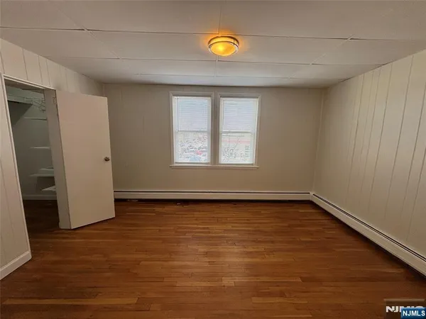 a view of a room with wooden floor and window
