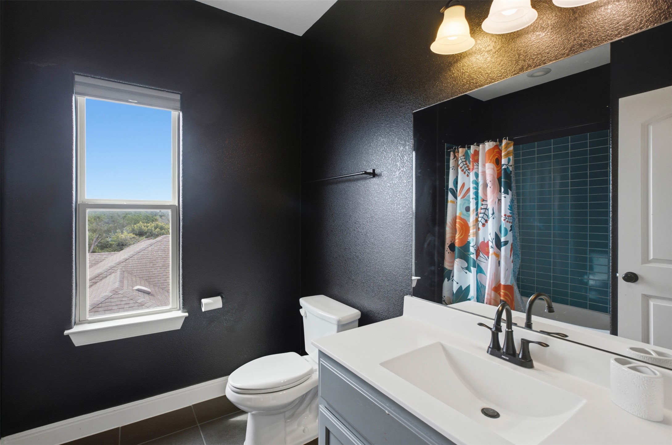 1113 Modoc Way Kyle, TX 78640 - Photo 25 of 34 A well-appointed bathroom features a bright window and contemporary vanity.