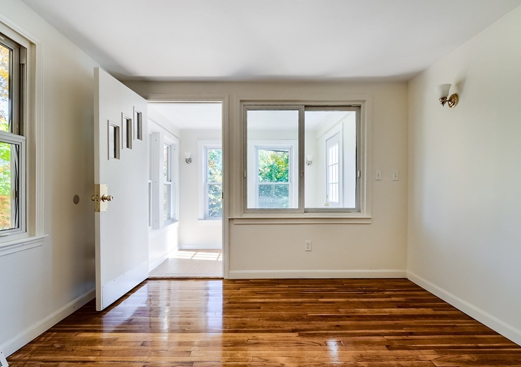 140 Leominster Road Sterling, MA 01564 - Photo 12 of 35 a view of an empty room with wooden floor and a window