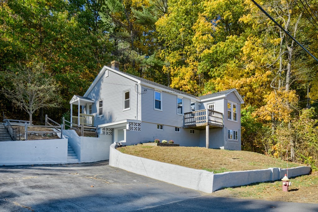 140 Leominster Road Sterling, MA 01564 - Photo 2 of 35 a front view of house with yard and trees in the background