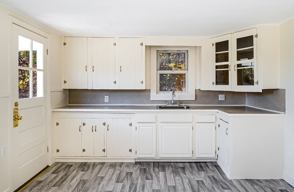140 Leominster Road Sterling, MA 01564 - Photo 4 of 35 a view of kitchen with granite countertop white cabinets and window