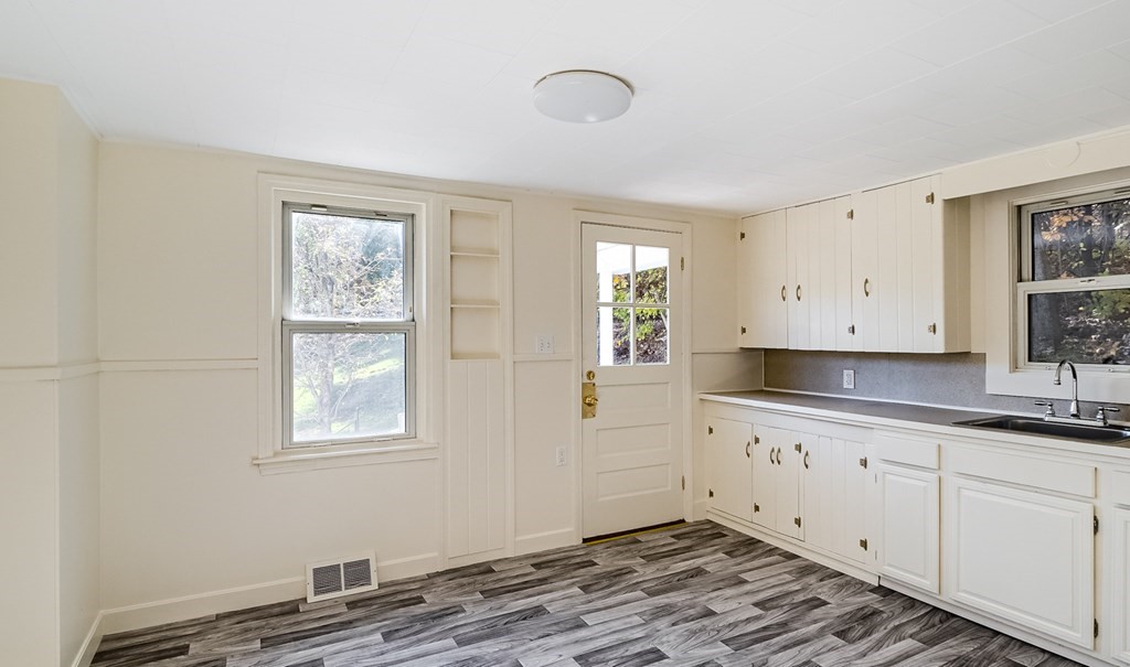 140 Leominster Road Sterling, MA 01564 - Photo 5 of 35 a kitchen with granite countertop white cabinets and window