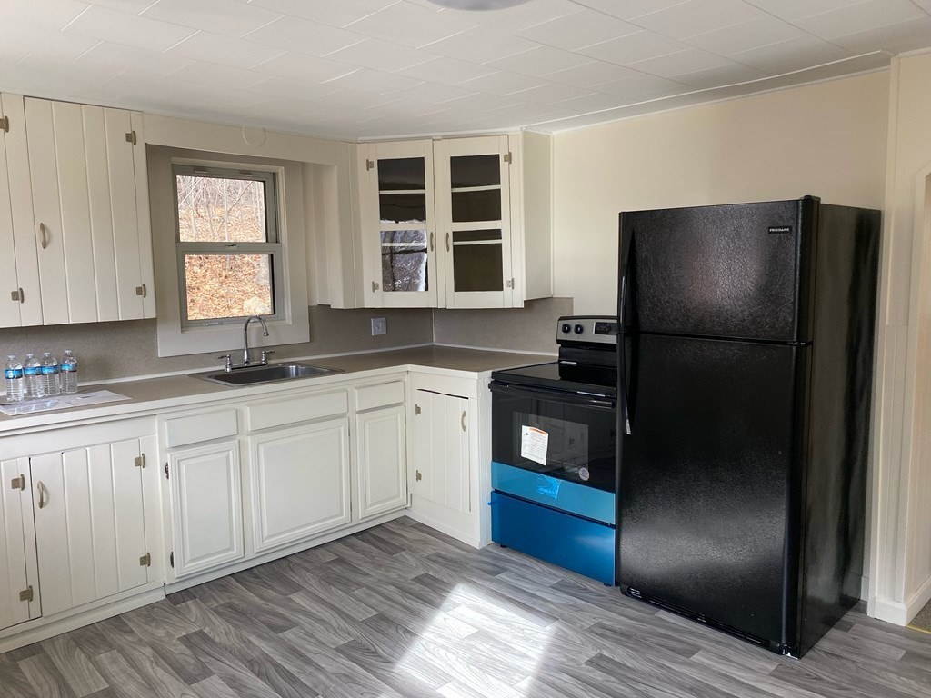 140 Leominster Road Sterling, MA 01564 - Photo 6 of 35 a kitchen with a refrigerator and window