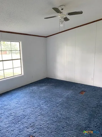 an empty room with a empty space and windows