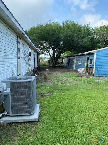 a view of backyard of house with green space