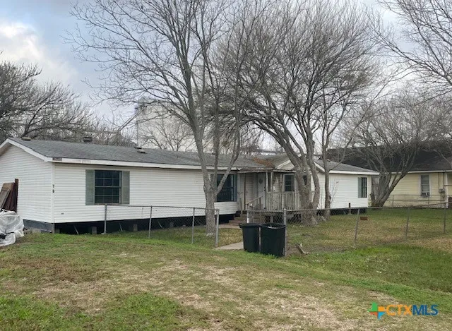 a view of a backyard with a large tree