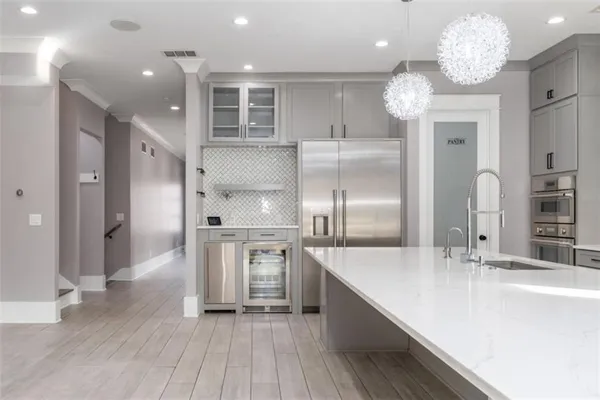 a view of a livingroom with wooden floor and a large window