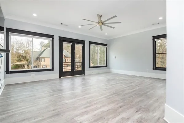 wooden floor in an empty room with a window