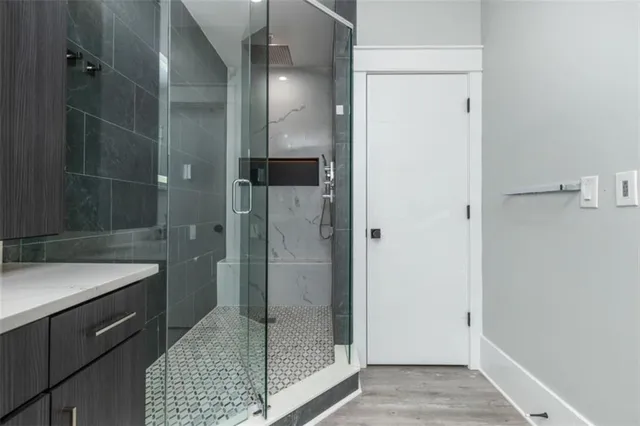 a hall with a sink cabinets and a wooden floor