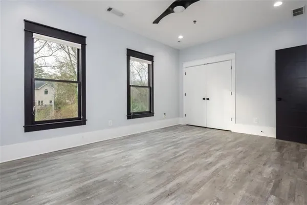 a view of walk in closet with empty racks