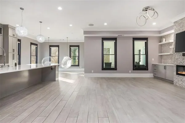 a large white kitchen with a large window