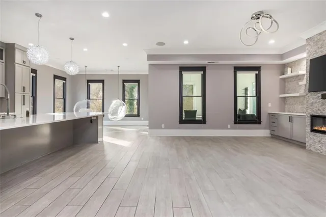 a large white kitchen with a large window