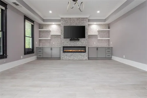 a large kitchen with stainless steel appliances granite countertop a lot of counter space and wooden floors