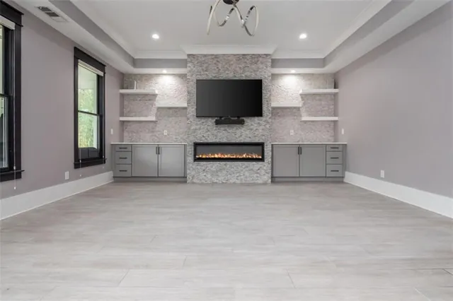 a large kitchen with stainless steel appliances granite countertop a lot of counter space and wooden floors