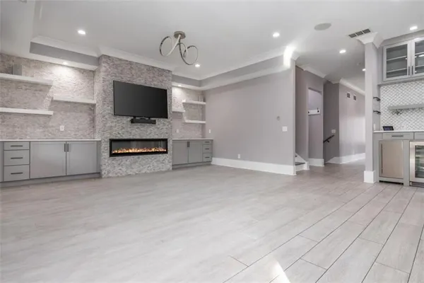 a large kitchen with stainless steel appliances kitchen island granite countertop a lot of counter space and wooden floors