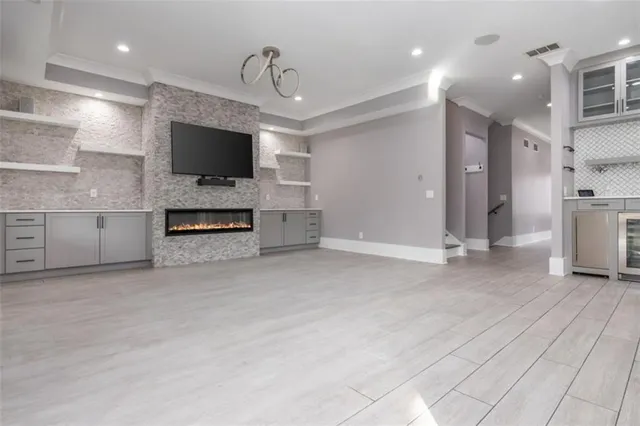 a large kitchen with stainless steel appliances kitchen island granite countertop a lot of counter space and wooden floors