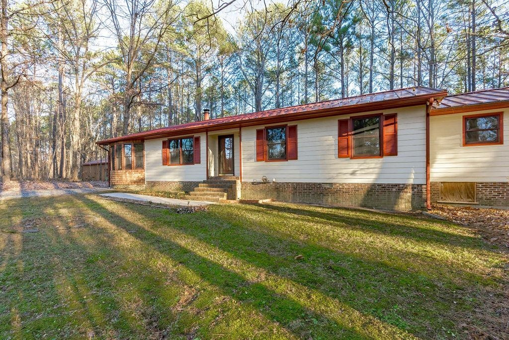 8933 Barker Road New Hill, NC 27562 - Photo 2 of 30 Nestled in the Shade of Mature Landscape for a More Energy Efficient Home