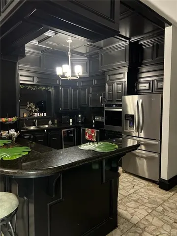 a kitchen with a sink and refrigerator