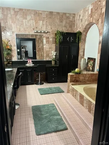 a living room with a bed and a dresser