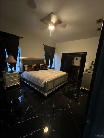 a bedroom with a bed and a mirror