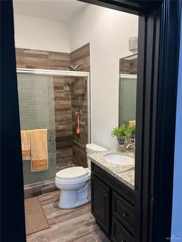 a bathroom with a granite countertop bathtub and toilet