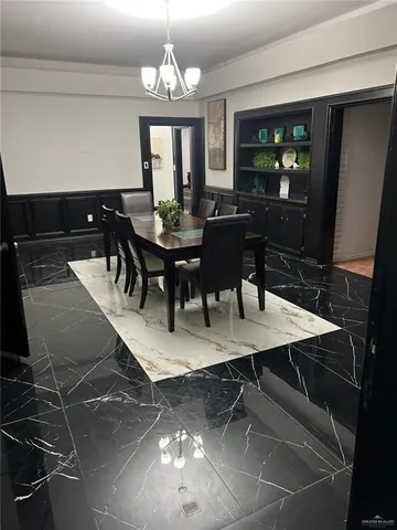 a view of a dining room with furniture and chandelier