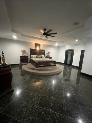 a living room with furniture and a view of kitchen