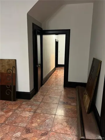 a view of a hallway with wooden floor and a hallway