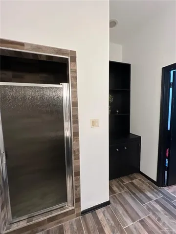a view of a utility room with closet and wooden floor
