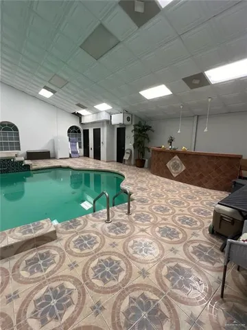 a swimming pool with yard in front of it