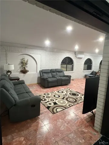 a living room with furniture rug and window