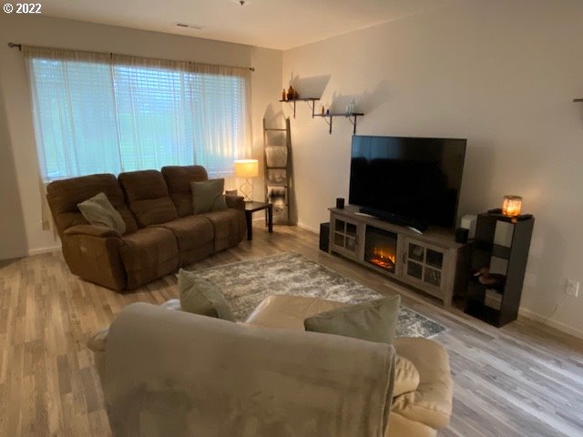 2018 South Taverner Drive Ridgefield, WA 98642 - Photo 12 of 32 a living room with furniture and a flat screen tv