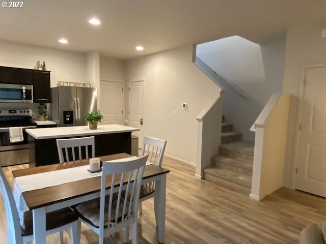 2018 South Taverner Drive Ridgefield, WA 98642 - Photo 15 of 32 a kitchen with a table chairs sink and cabinets
