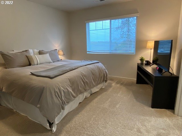 2018 South Taverner Drive Ridgefield, WA 98642 - Photo 18 of 32 a bedroom with a bed and a window