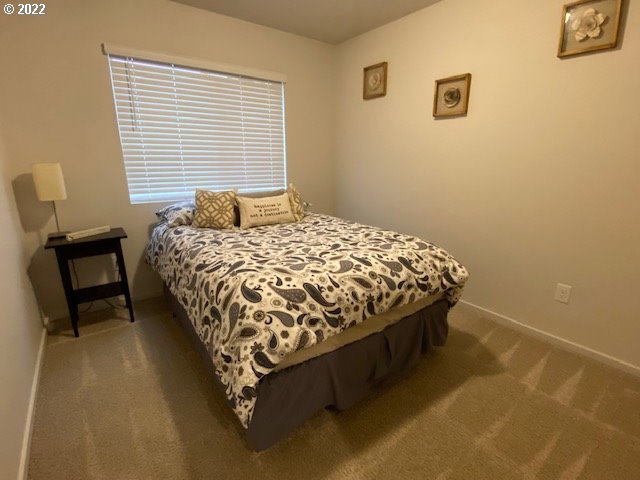 2018 South Taverner Drive Ridgefield, WA 98642 - Photo 23 of 32 a bed sitting in a bedroom next to a window