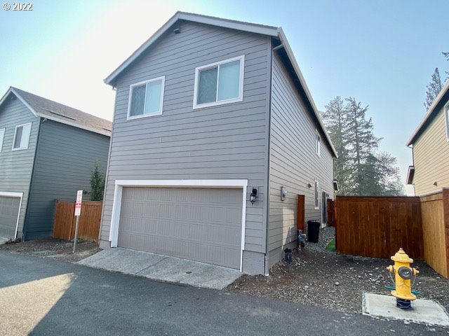 2018 South Taverner Drive Ridgefield, WA 98642 - Photo 26 of 32 a view of a house with a yard and garage