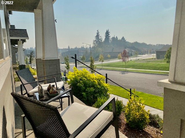 2018 South Taverner Drive Ridgefield, WA 98642 - Photo 29 of 32 a view of a balcony with two chairs and a potted plant