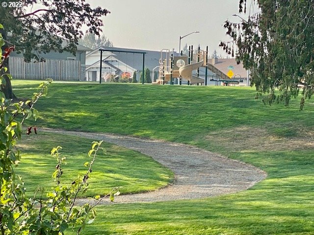 2018 South Taverner Drive Ridgefield, WA 98642 - Photo 30 of 32 a backyard of a house with lots of green space and trees