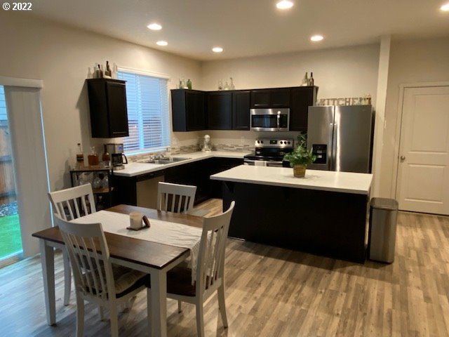 2018 South Taverner Drive Ridgefield, WA 98642 - Photo 7 of 32 a large kitchen with a table and chairs