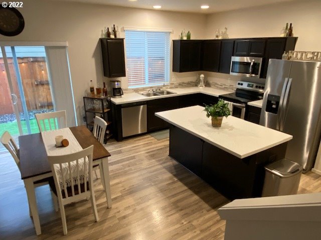 2018 South Taverner Drive Ridgefield, WA 98642 - Photo 8 of 32 a kitchen with stainless steel appliances kitchen island granite countertop a sink a stove and refrigerator