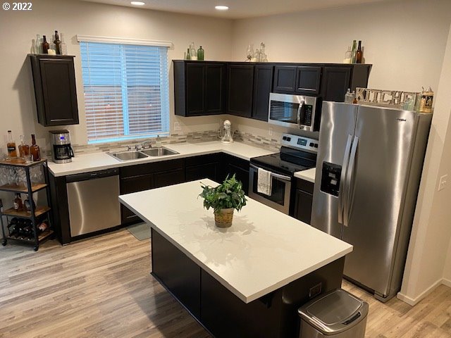 2018 South Taverner Drive Ridgefield, WA 98642 - Photo 9 of 32 a kitchen with stainless steel appliances a sink stove refrigerator and cabinets