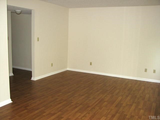 5915 Farm Gate Road Raleigh, NC 27606 - Photo 8 of 11 an empty room with wooden floor