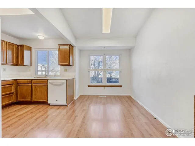 a open kitchen with a sink cabinets and wooden floor