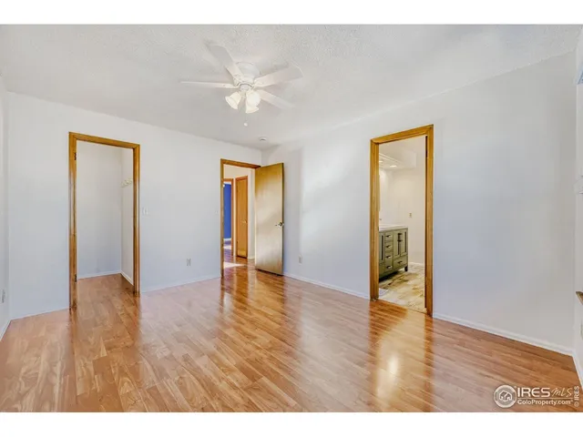 a view of an empty room and wooden floor